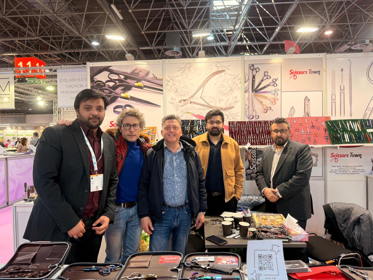 A photograph with visitors at the Scissors Town stand. Beauty Düsseldorf 2025.