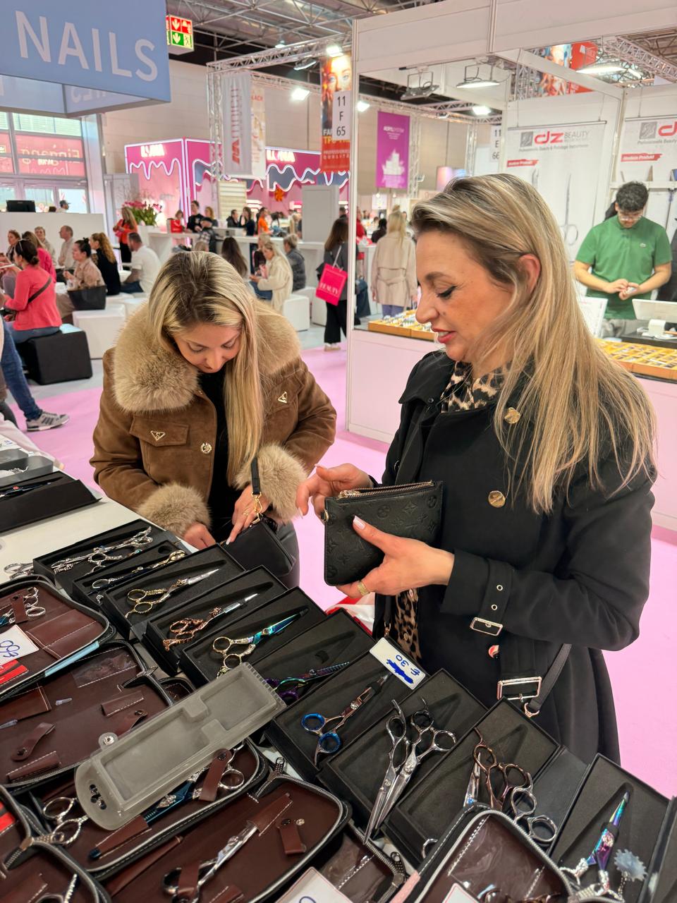 Visitors examine scissors displayed in individual cases. Beauty Düsseldorf 2026.
