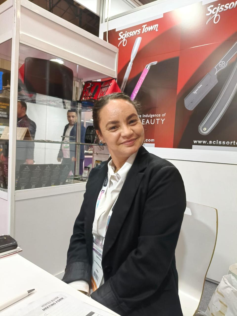 An exhibition visitor beside our instrument sets and product posters. Beauty Istanbul 2025.