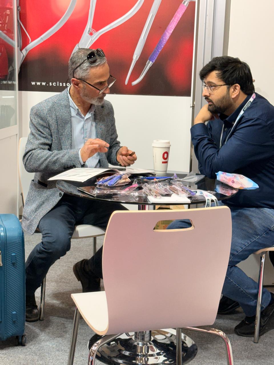 A conversation at the stand with catalogues and sample products on the table. Beauty Istanbul 2026.