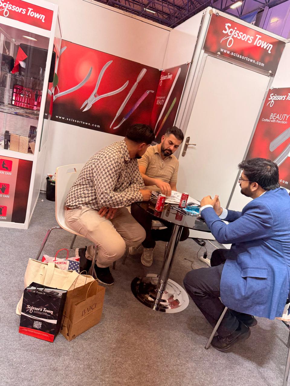 Visitors discuss the catalogue with our team at the stand. Beauty Istanbul 2026.